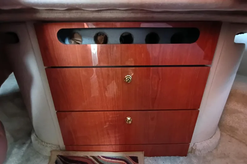 Slide: The Image of 1997 Sea Ray 370 Aft Cabin interior with wooden drawers and brass handles. - 55