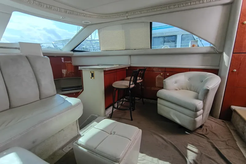 Slide: The Image of Luxurious interior of 1997 Sea Ray 370 Aft Cabin yacht with plush seating. - 56