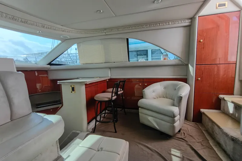 Slide: The Image of 1997 Sea Ray 370 Aft Cabin interior with plush seating and wooden cabinetry. - 57