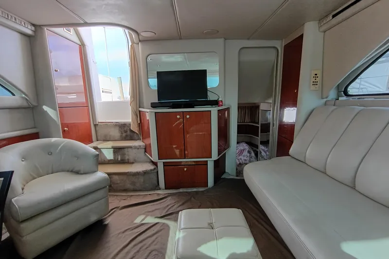 Slide: The Image of Interior of 1997 Sea Ray 370 Aft Cabin with seating, TV, and steps. - 59