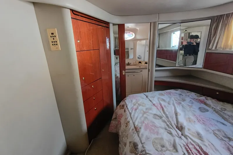 Slide: The Image of Interior of 1997 Sea Ray 370 Aft Cabin with wood cabinetry and cozy bedding. - 61