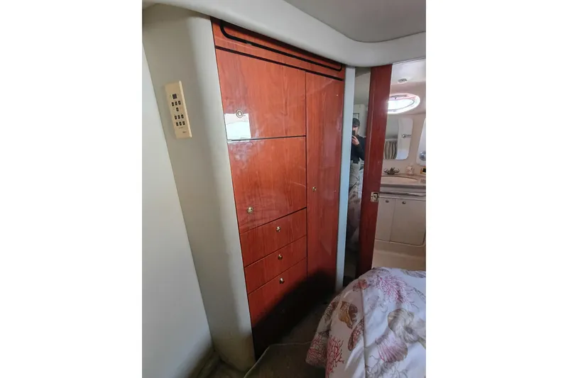 Slide: The Image of 1997 Sea Ray 370 Aft Cabin interior with wooden cabinetry and adjacent bathroom. - 62