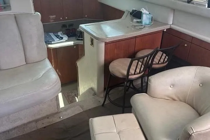 Slide: The Image of 1997 Sea Ray 370 Aft Cabin docked, featuring a life ring and fenders. - 7