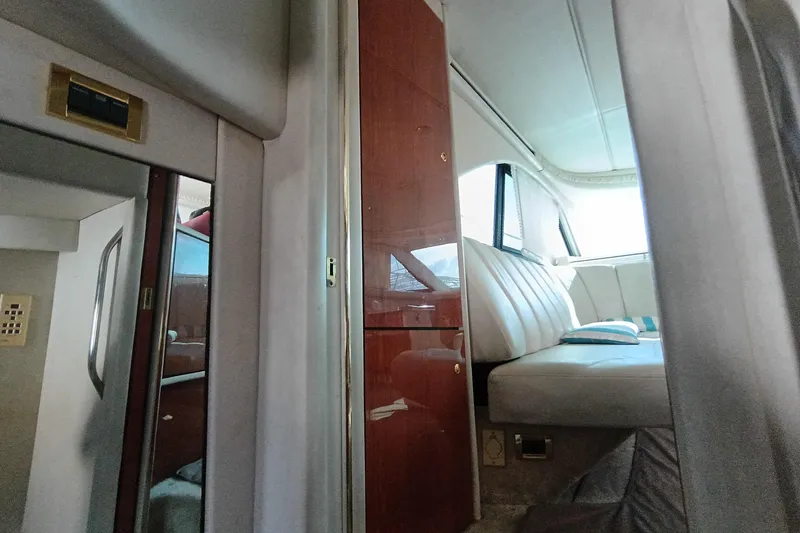 Slide: The Image of Interior of 1997 Sea Ray 370 Aft Cabin with seating and wood paneling. - 71