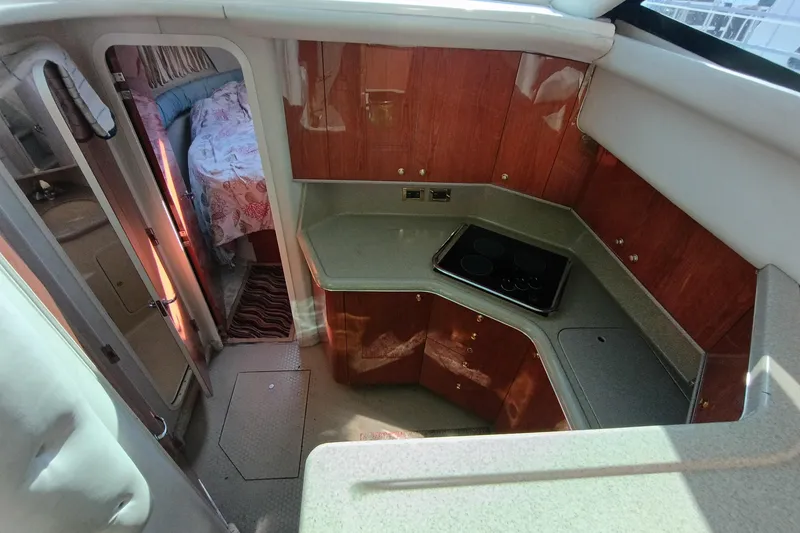 Slide: The Image of Interior of 1997 Sea Ray 370 Aft Cabin with kitchen and bedroom view. - 73