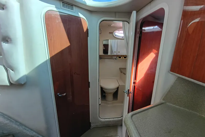 Slide: The Image of Interior of 1997 Sea Ray 370 Aft Cabin yacht showing bathroom and wooden cabinetry. - 84
