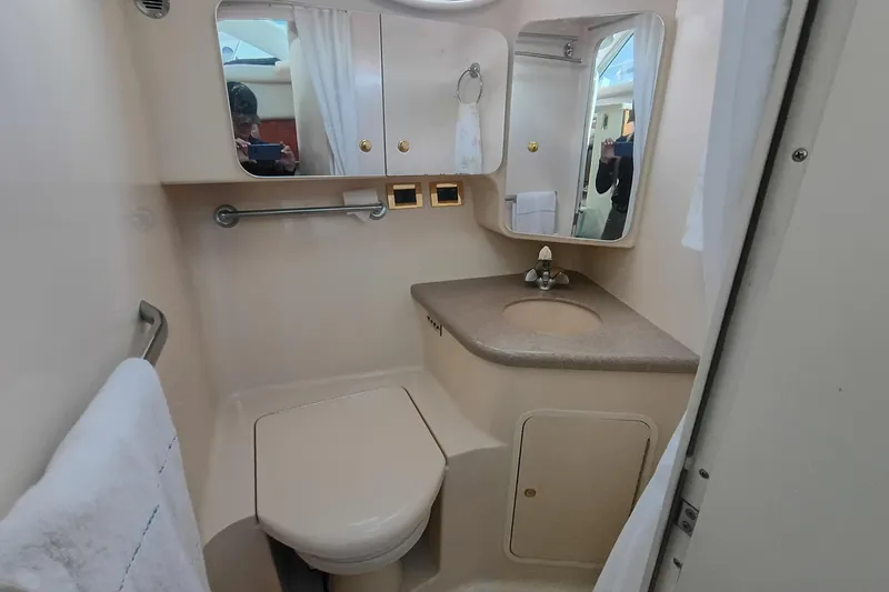 Slide: The Image of 1997 Sea Ray 370 Aft Cabin bathroom with sink, mirror, and toilet. - 85