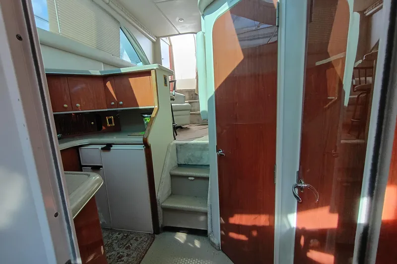 Slide: The Image of Interior of 1997 Sea Ray 370 Aft Cabin yacht with wooden cabinetry and stairs. - 92
