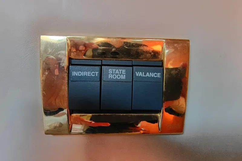 Slide: The Image of Switch panel on 1997 Sea Ray 370 Aft Cabin yacht with gold trim. - 93