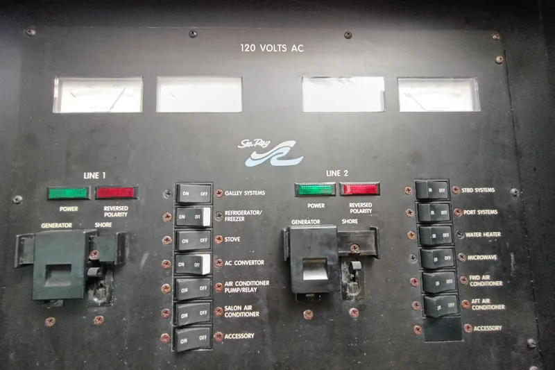 Slide: The Image of Electrical control panel of a 1997 Sea Ray 370 Aft Cabin boat, showing switches and indicators. - 96