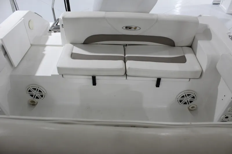 Slide: The Image of 2012 Sea Hunt Edge 24 boat interior with cushioned seating and built-in speakers. - 10