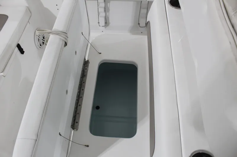 Slide: The Image of 2012 Sea Hunt Edge 24 boat interior with open storage compartment. - 14