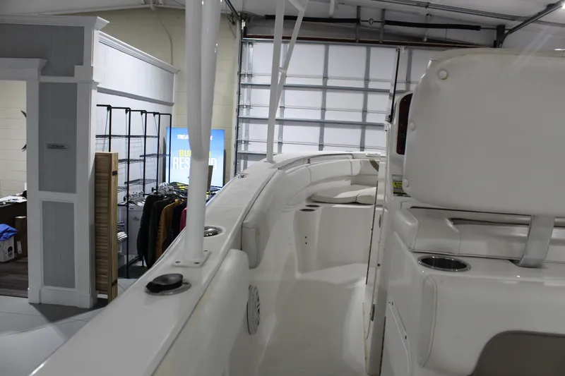 Slide: The Image of 2012 Sea Hunt Edge 24 boat interior in a showroom setting. - 16