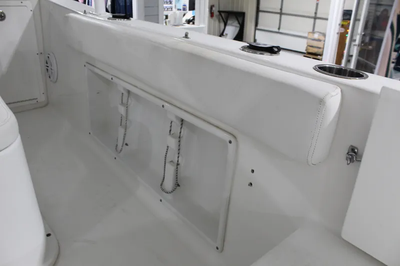 Slide: The Image of Interior view of a 2012 Sea Hunt Edge 24 boat, featuring white seating and storage. - 17