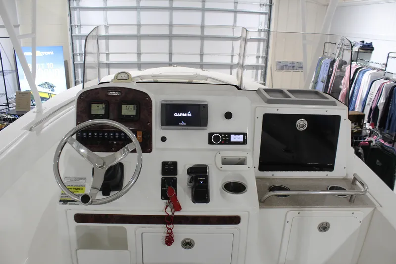 Slide: The Image of 2012 Sea Hunt Edge 24 boat dashboard with Garmin navigation system and steering wheel. - 19