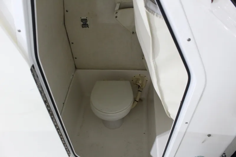 Slide: The Image of 2012 Sea Hunt Edge 24 boat interior with compact marine toilet. - 24