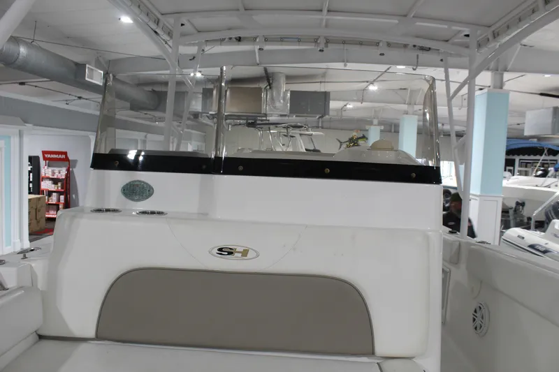 Slide: The Image of 2012 Sea Hunt Edge 24 boat interior with console and seating in showroom. - 25