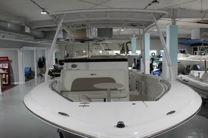 Slide: The Image of 2012 Sea Hunt Edge 24 boat displayed in a showroom with modern interior. - 3