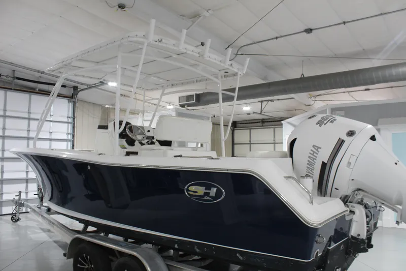 Slide: The Image of 2012 Sea Hunt Edge 24 boat with Yamaha engine in a garage setting. - 5