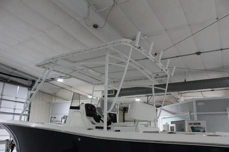 Slide: The Image of 2012 Sea Hunt Edge 24 boat in indoor showroom, featuring T-top and console. - 8