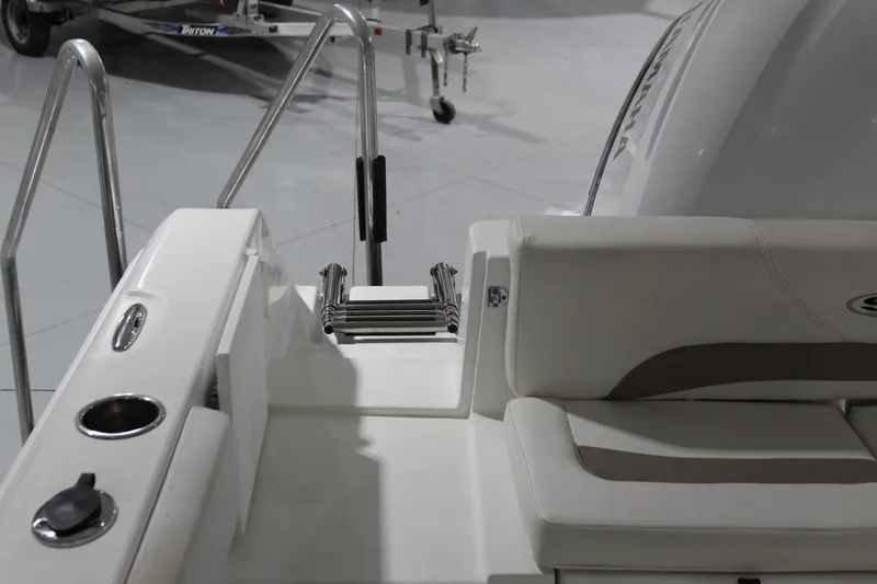 Slide: The Image of 2012 Sea Hunt Edge 24 boat interior with seating and ladder, showcasing sleek design. - 9