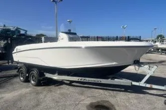 Slide: The Image of 2022 Wellcraft 202 Fisherman boat on trailer, parked outdoors under clear blue sky. - 1