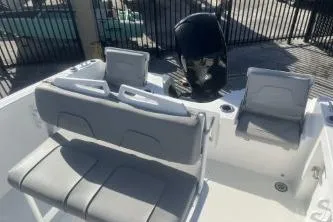 Slide: The Image of 2022 Wellcraft 202 Fisherman boat interior with seating and motor. - 10