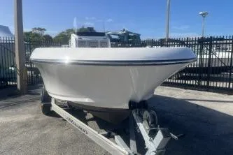 Slide: The Image of 2022 Wellcraft 202 Fisherman boat on trailer, parked outdoors. - 2