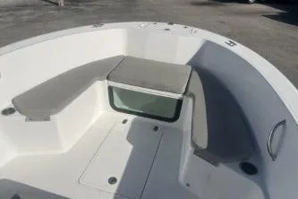 Slide: The Image of 2022 Wellcraft 202 Fisherman boat interior with cushioned seating and storage. - 8