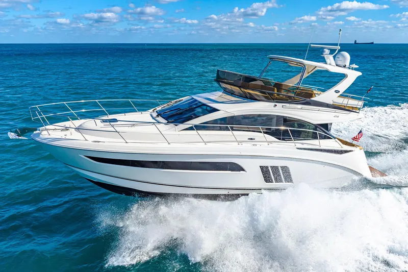 Slide: The Image of 2016 Sea Ray 510 Fly yacht cruising on open ocean under clear skies. - 10
