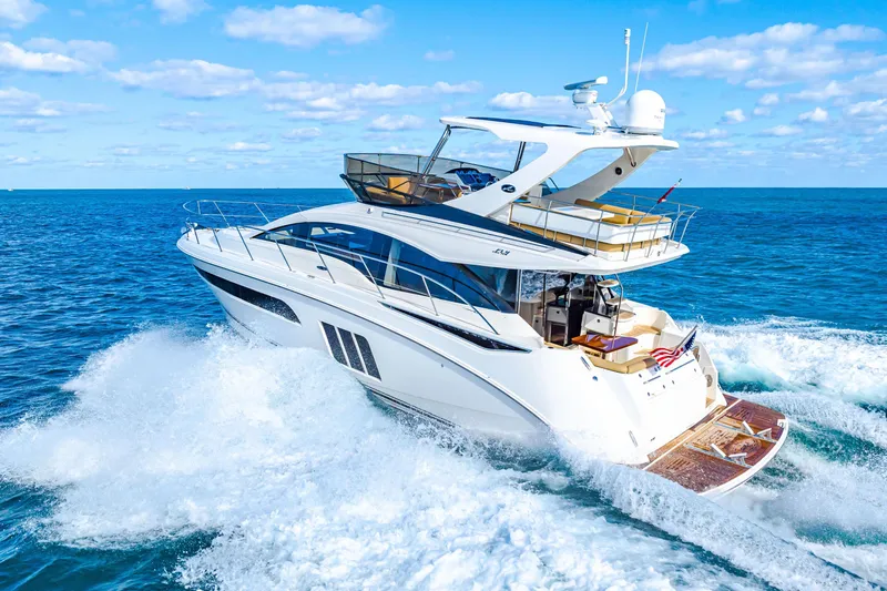 Slide: The Image of 2016 Sea Ray 510 Fly yacht cruising on open ocean under clear blue sky. - 11