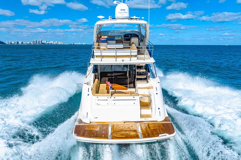 Slide: The Image of 2016 Sea Ray 510 Fly yacht cruising on open ocean under blue sky. - 12