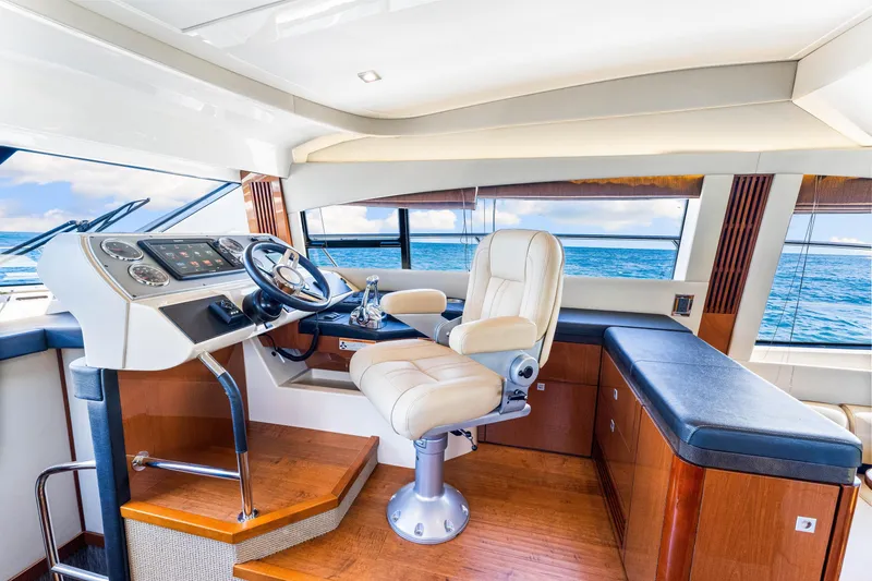 Slide: The Image of Luxurious 2016 Sea Ray 510 Flybridge interior with helm, leather seating, and ocean view. - 28