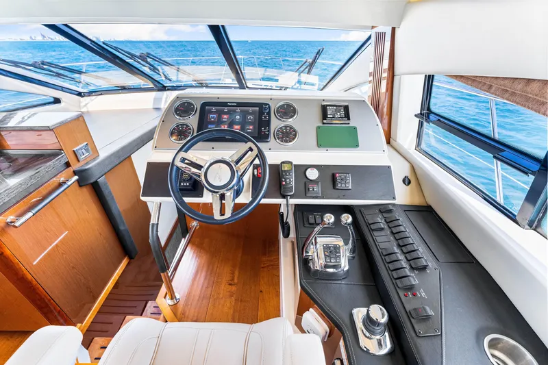 Slide: The Image of 2016 Sea Ray 510 Fly yacht helm with modern controls and ocean view. - 29
