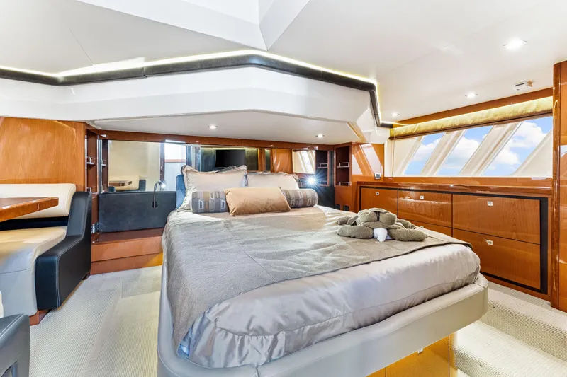 Slide: The Image of Luxurious 2016 Sea Ray 510 Fly yacht bedroom with elegant wood finishes and modern decor. - 33