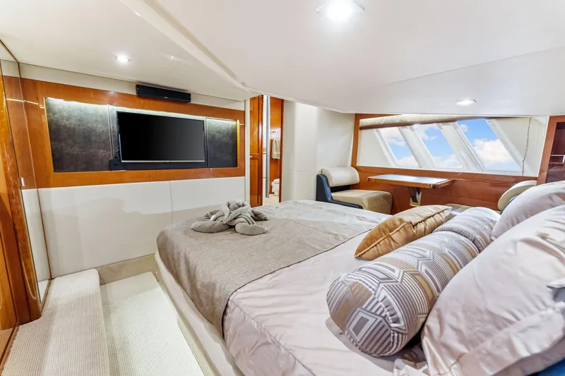 Slide: The Image of Luxurious 2016 Sea Ray 510 Fly yacht bedroom with modern decor and large windows. - 34