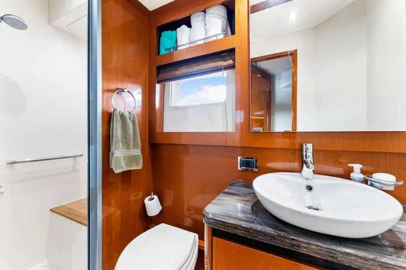 Slide: The Image of Luxurious 2016 Sea Ray 510 Fly yacht bathroom with modern fixtures and elegant wood finish. - 37