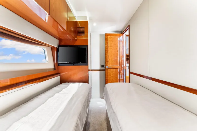 Slide: The Image of Luxurious cabin interior of 2016 Sea Ray 510 Fly yacht with twin beds and TV. - 43