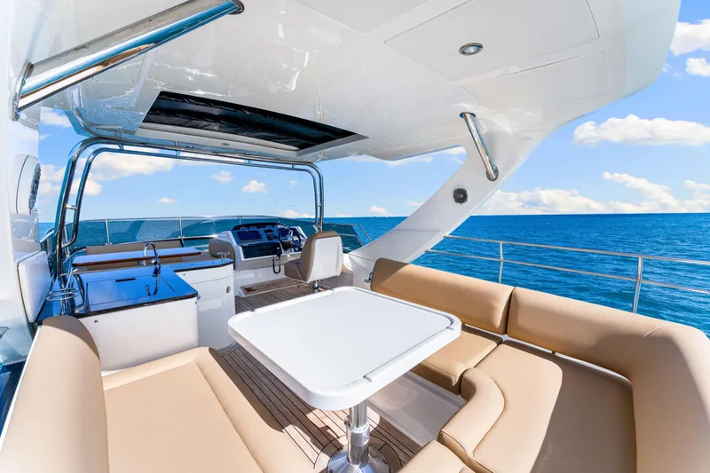 Slide: The Image of Luxurious 2016 Sea Ray 510 Fly yacht interior with ocean view, featuring elegant seating and helm. - 47
