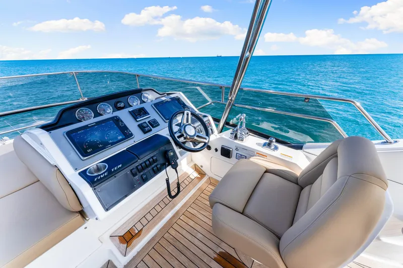 Slide: The Image of Luxurious 2016 Sea Ray 510 Fly yacht helm with ocean view and modern controls. - 50