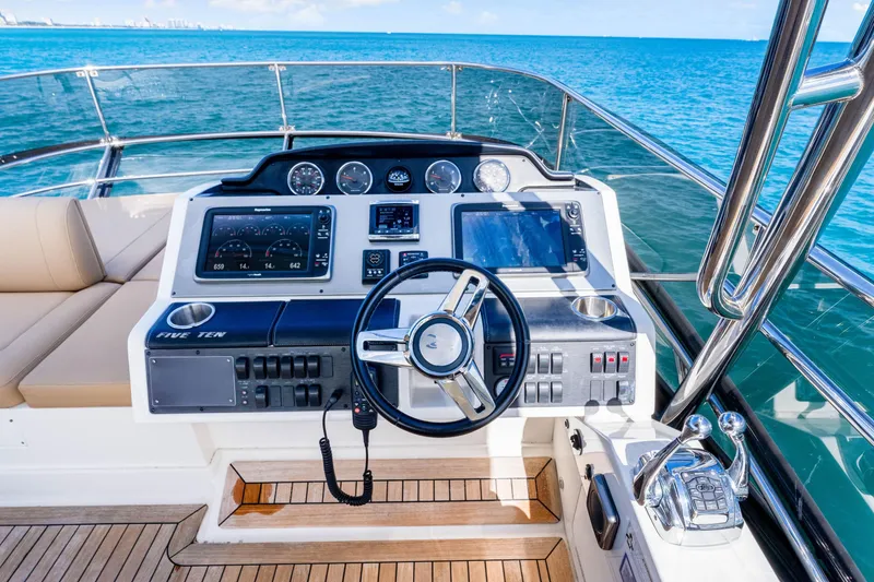 Slide: The Image of 2016 Sea Ray 510 Flybridge helm with ocean view, featuring modern navigation controls. - 51