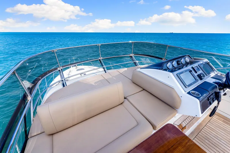 Slide: The Image of Luxurious 2016 Sea Ray 510 Fly yacht helm with ocean view and modern controls. - 54