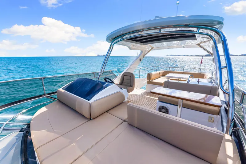 Slide: The Image of Luxurious 2016 Sea Ray 510 Fly yacht on open water, featuring spacious deck and seating. - 56