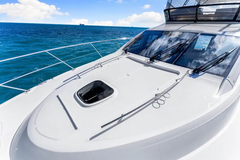 Slide: The Image of 2016 Sea Ray 510 Fly yacht on open sea with clear blue skies. - 58