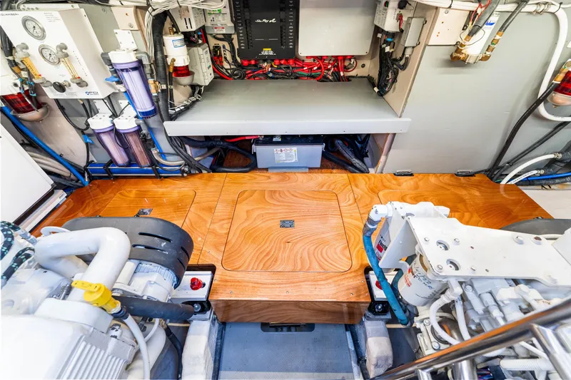 Slide: The Image of Engine room of a 2016 Sea Ray 510 Fly yacht, showcasing equipment and wooden flooring. - 65