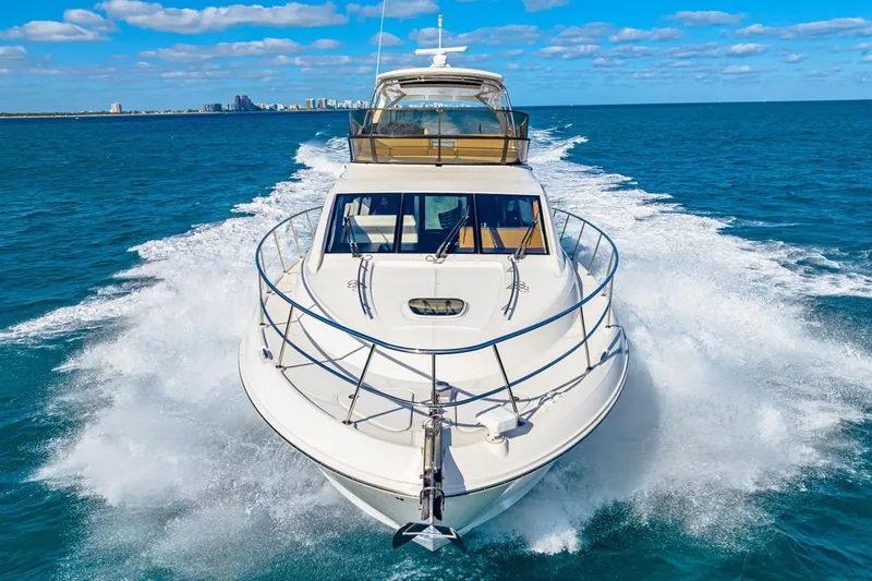 Slide: The Image of 2016 Sea Ray 510 Fly yacht cruising on open water under a clear blue sky. - 7