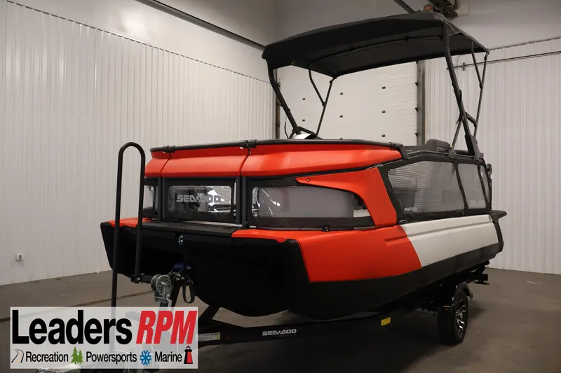 Slide: The Image of 2024 Sea-Doo Switch Cruise 18 in showroom, featuring vibrant red and black design. - 0