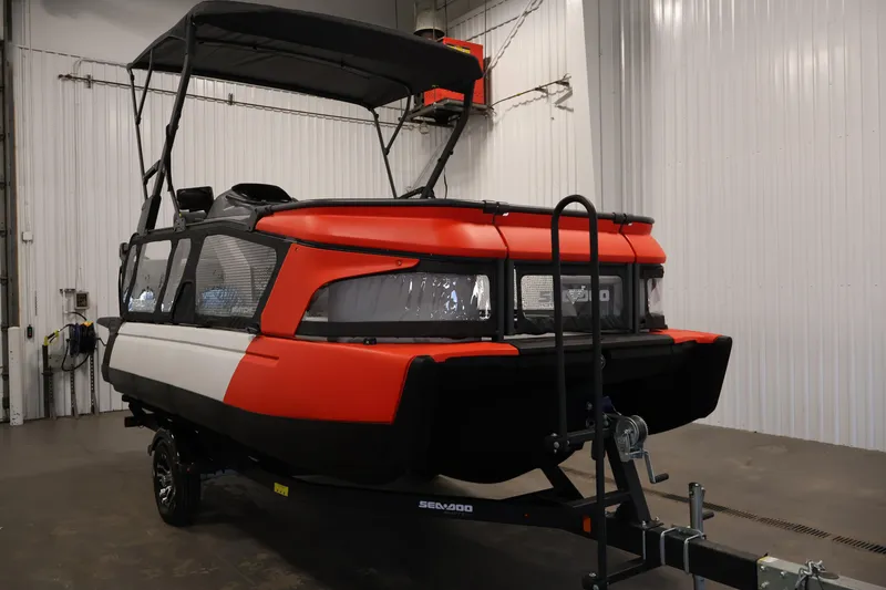 Slide: The Image of 2024 Sea-Doo Switch Cruise 18 in a garage, showcasing its vibrant design and trailer. - 2