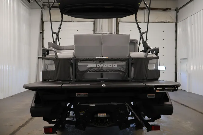 Slide: The Image of 2024 Sea-Doo Switch Cruise 18 pontoon boat on trailer in indoor setting. - 5