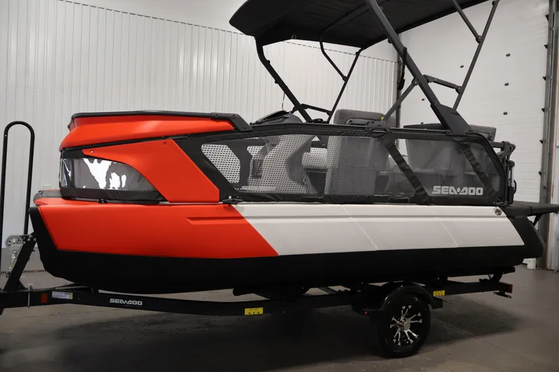 Slide: The Image of 2024 Sea-Doo Switch Cruise 18 pontoon boat in a garage, rear view. - 7